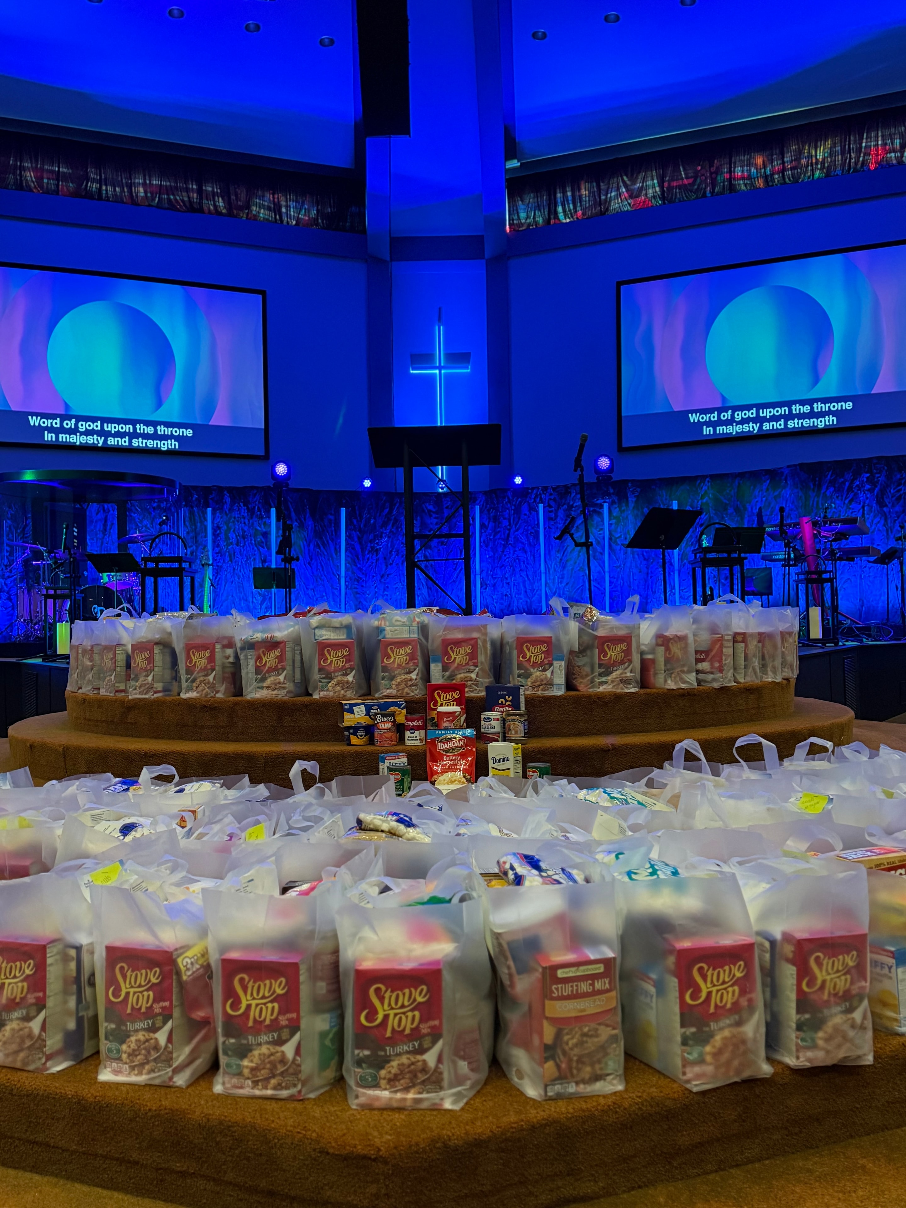 Hundreds of filled Bags of Blessings covering a church sanctuary floor, ready for distribution