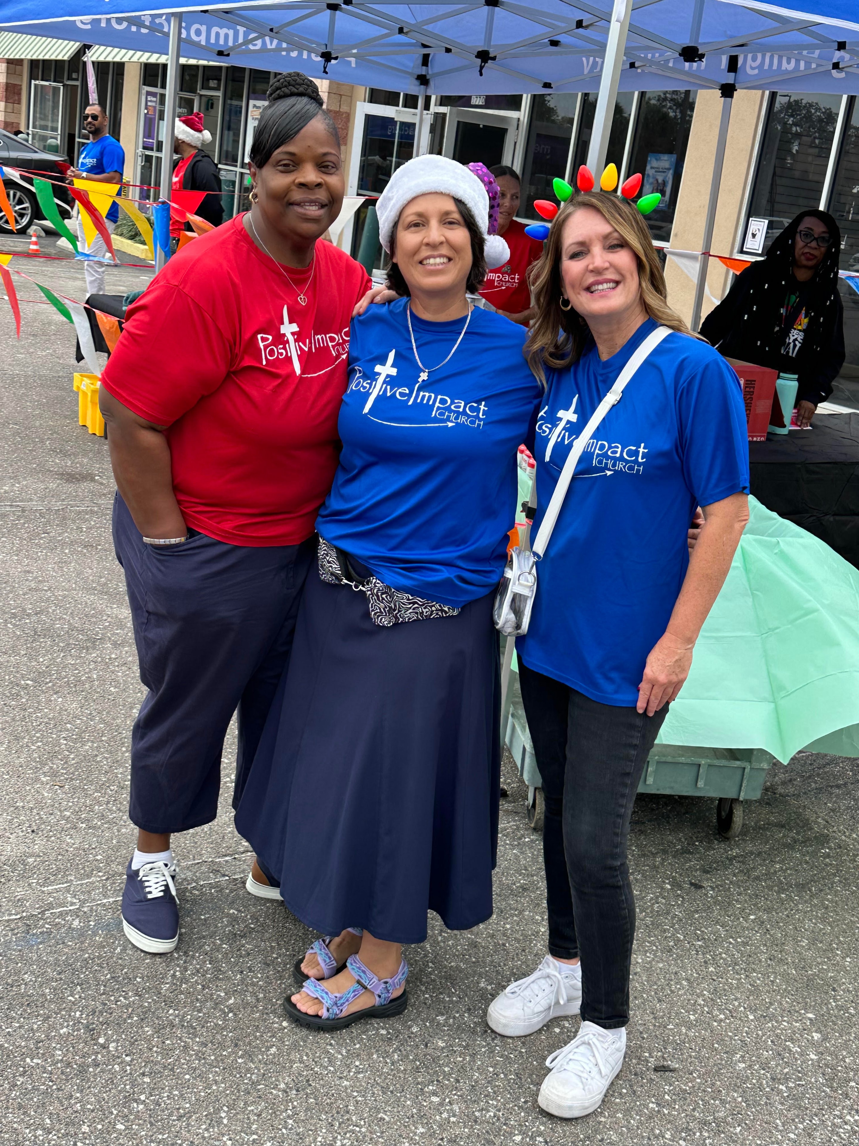 Positive Impact team volunteers smiling together at a holiday distribution event