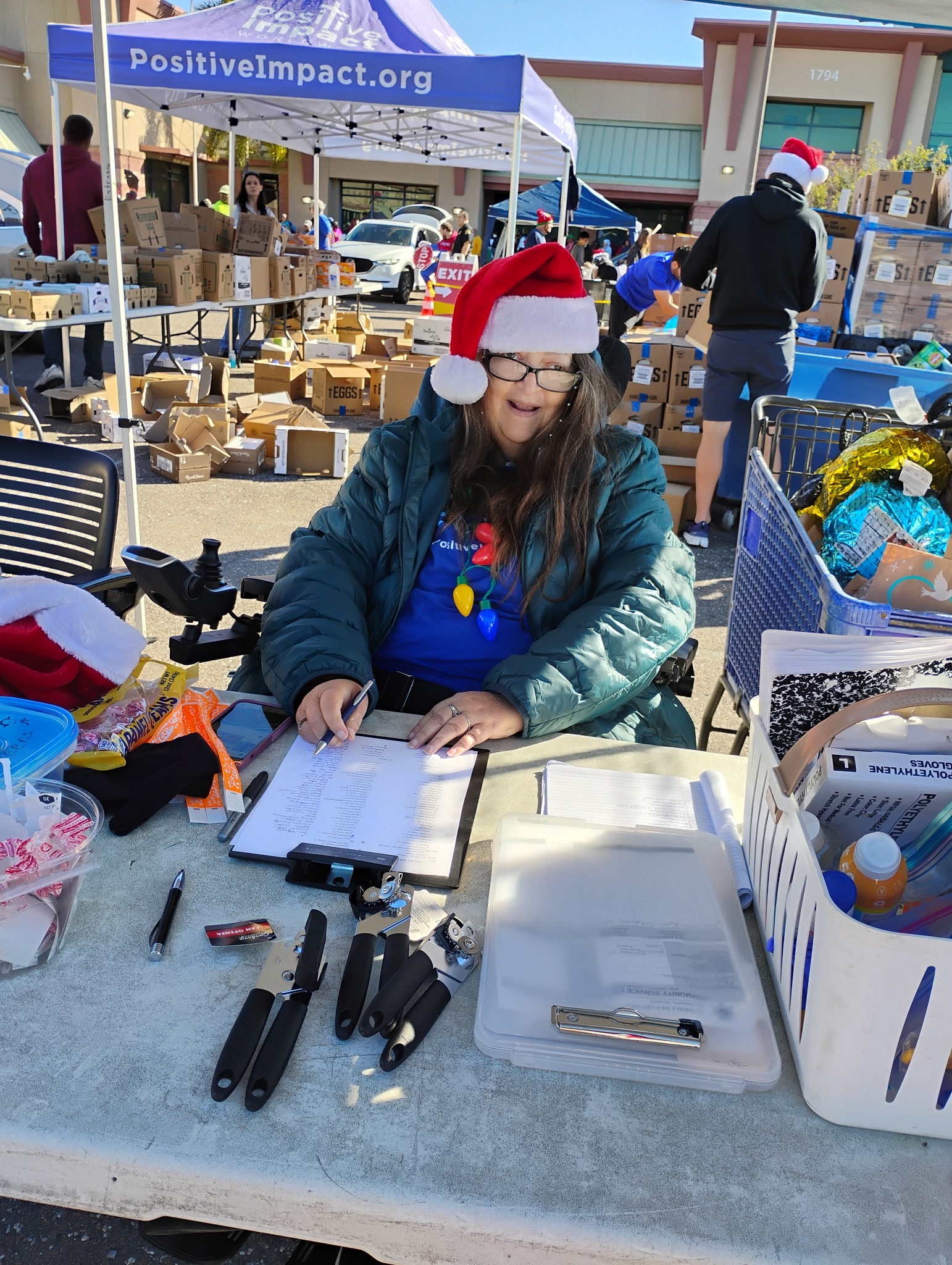 Positive Impact volunteer at the holiday distribution check-in table