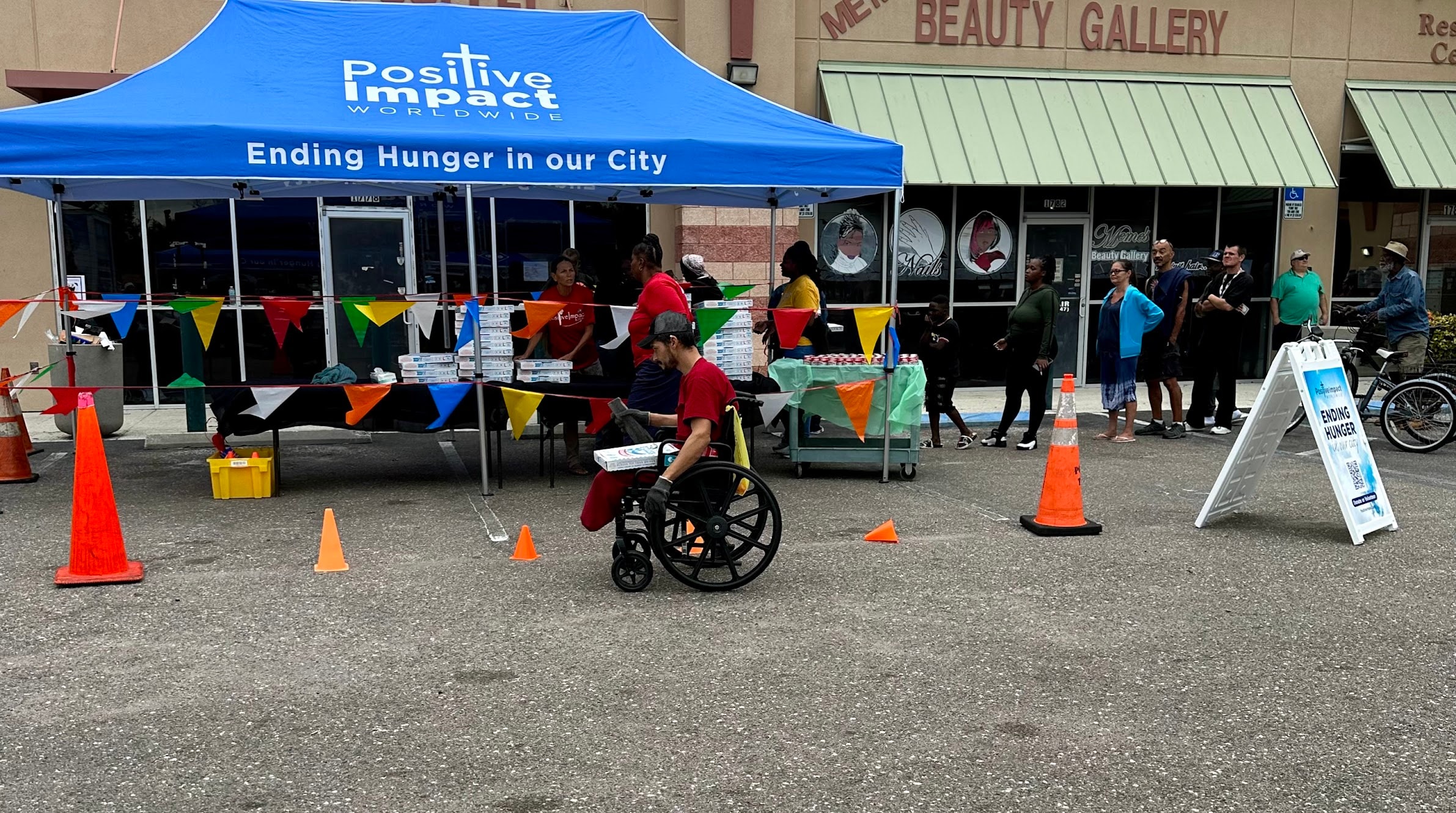 Positive Impact Worldwide tent at a Saturday food distribution event