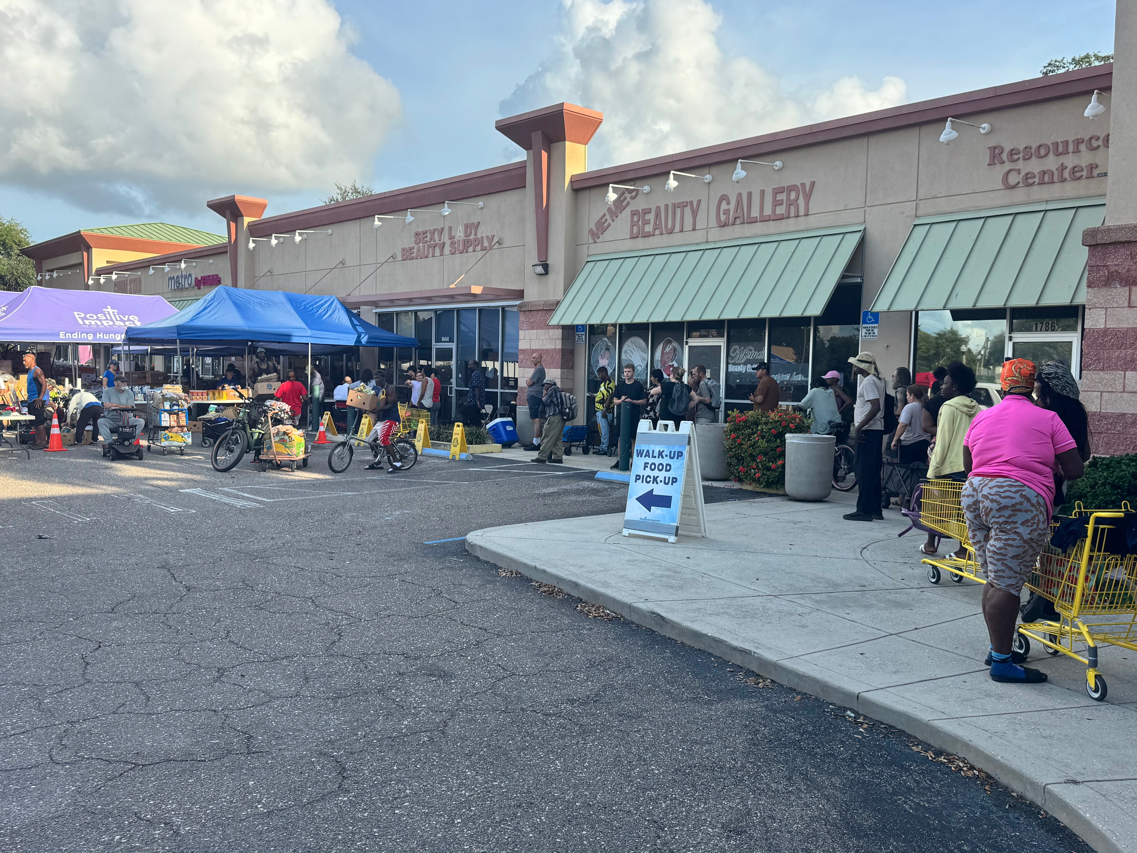 Community members lined up for walk-up food pick-up at Tangerine Plaza